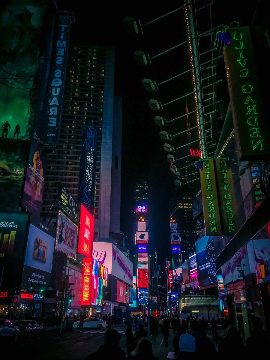 urban group of people walking on New York Timesquare during nighttime city